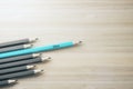 Creativity inspiration and idea concept with row of grey pencils and one blue standing out from the rest on wooden surface Royalty Free Stock Photo