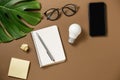 Creativity for success. Ideas inspiration concepts with lightbulb, modern smartphone, pen, monstera leaves, eyeglasses, notebook