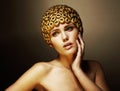 Creativity. Surreal Portrait of Stylized Woman with Golden Headwear as a Helmet