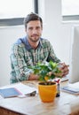 Creativity thrives in this office. Portrait of a young designer working on a computer in an office.