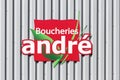 Boucheries Andre logo on a wall