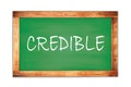 CREDIBLE text written on green school board