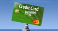 This is a credit card balanced on rocks to illustrate the idea of credit card balances.