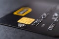 Credit card with chip and contactless technology macro. Black debit card for cash withdrawals and money transfers. Payment for