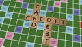 Credit card debt crossword on fake scrabble board