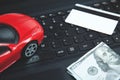 Credit card, dollar and red toy car on laptop keyboard Royalty Free Stock Photo