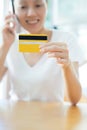 credit card in hand of female speaking mobile