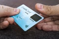 Credit card has built-in fingerprint scanner. Illustration of biometric payment security. One male hand is holding blue card and