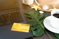 A credit card is placed on the computer and has a cup of coffee next to the top view Royalty Free Stock Photo
