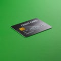 A credit card is placed on a vibrant green surface, angled slightly away from the Royalty Free Stock Photo