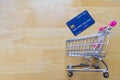 Credit card and shopping cart on wooden table. online shopping, online payment. Royalty Free Stock Photo