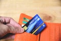 Credit card in wallet with hand - online paying from home or Increased liabilities debt credit card concept