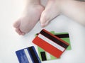 Credit cards and baby feet Royalty Free Stock Photo