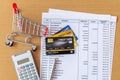 Credit cards and Cart supermarket and Calculator on Bank statement on a Wooden table Royalty Free Stock Photo