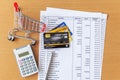 Credit cards and Cart supermarket and Calculator on Bank statement on a Wooden table Royalty Free Stock Photo