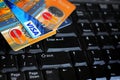 Credit cards on computer keyboard with brand logos VISA and MASTERCARD Royalty Free Stock Photo