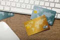 Credit cards, computer keyboard and mouse on wooden background, flat lay Royalty Free Stock Photo