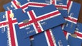 Pile of credit cards with flag of Iceland. Icelandic banking system conceptual 3D rendering