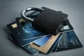 Credit cards and padlock on grey background. Protection from cyber attack Royalty Free Stock Photo