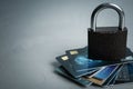 Credit cards and padlock on grey background, space for text. Protection from cyber attack Royalty Free Stock Photo