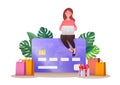 Credit or debit card payment business concept. Vector flat illustration of woman using laptop sitting on top of a credit card
