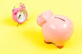 Credit debt. It is time to pay. Piggy bank pink pig and little alarm clock. Financial crisis. Economics and finance Royalty Free Stock Photo