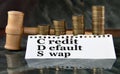 CREDIT DEFAULT SWAP - word on a white sheet with a judge\'s gavel and a stack of coins in the background Royalty Free Stock Photo