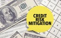 CREDIT RISK MITIGATION words on yellow sticker with dollars and charts
