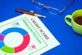 Credit score form on the blue desk with glasses and stylish pen. Business idea of working environment in an office Royalty Free Stock Photo