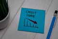Credit Score write on sticky note on wooden table