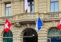 Credit Suisse building at Paradeplatz square in the city of Zurich decorated with flags