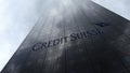 Credit Suisse Group logo on a skyscraper facade reflecting clouds. Editorial 3D rendering