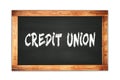 CREDIT UNION text written on wooden frame school blackboard