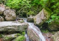 The creek flows down between the large stones Royalty Free Stock Photo