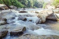 Creek and river flowing through along rocks Royalty Free Stock Photo