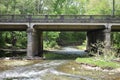 Creek running under a bridge in  a wooded area in rural Tennessee Royalty Free Stock Photo