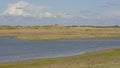 Creek in a salt marsh in Zwin nature reserve , with creeks and dunes . Knokke, Belgium