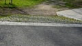 Creek in terrain notch overgrown with spring meadow lush green colors trees park pedal path of stone concrete block slab tread tra Royalty Free Stock Photo