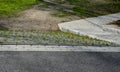 Creek in terrain notch overgrown with spring meadow lush green colors trees park pedal path of stone concrete block slab tread tra Royalty Free Stock Photo