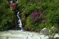 Creek tributary flows into small mountain river Royalty Free Stock Photo