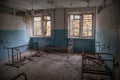 Creepy, abandoned, old room with beds and windows in building located in the Chernobyl ghost town