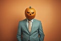 Creepy businessman wearing a carved pumpkin mask. Royalty Free Stock Photo