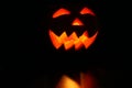 Creepy carved pumpkin face in dark Royalty Free Stock Photo