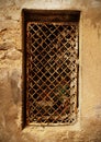 Creepy dark cell window grates in old brown concrete wall Royalty Free Stock Photo