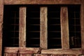 Creepy dark cell window in old brown wooden wall Royalty Free Stock Photo