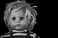 Creepy doll`s head of a young boy on black background Royalty Free Stock Photo