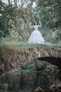 Creepy dead bride standing on the bridge. Halloween scene