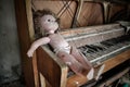 Creepy doll on a piano in an abandoned building in Pripyat, Ukraine, site of the 1986 Chernobyl nuclear desaster.