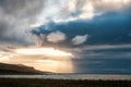 Creepy face on dramatic stormy sky and white clouds as eyes and sea water