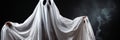 Creepy ghost costume with copy space for halloween concept - person covered with white sheet